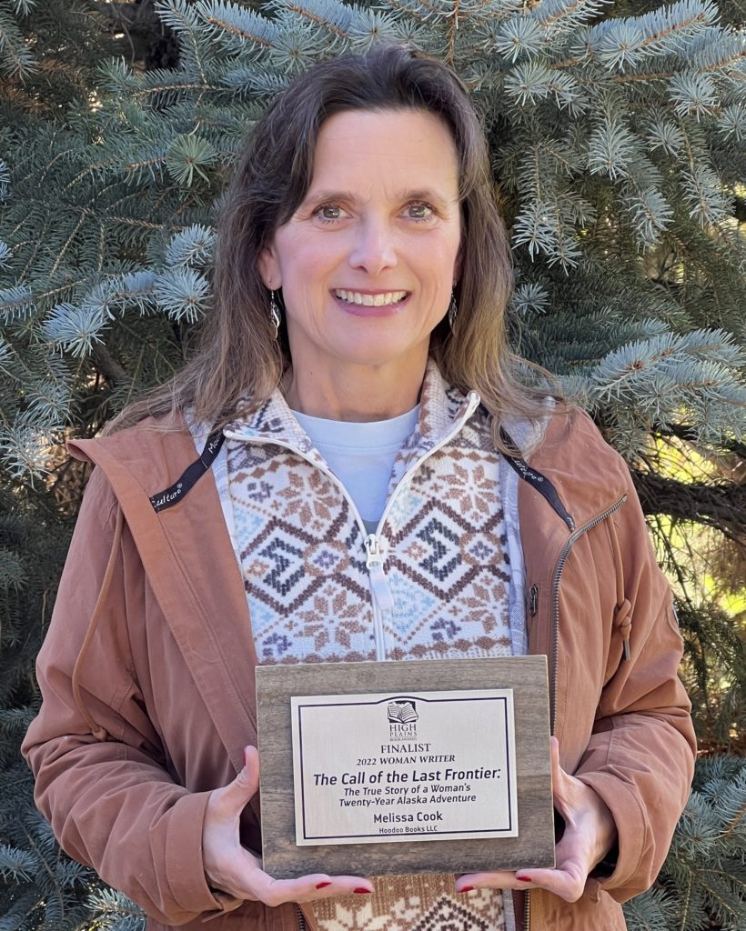 Melissa Cook hold her High Plains Book Award Finalist Plaque2022