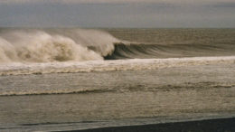 Nelson Lagoon black sand beach with Bering Sea wind blowing the waves