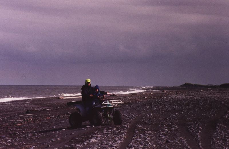 Elgin & Ethan Cook on a four-wheeler on the Bering Sea bundled up for the cold
