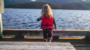 Evey Cook on the Thorne Bay Dock wearing a Kids Don't Float life jacket