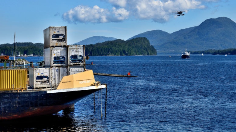 Barge with floatplane and ferry in the background
