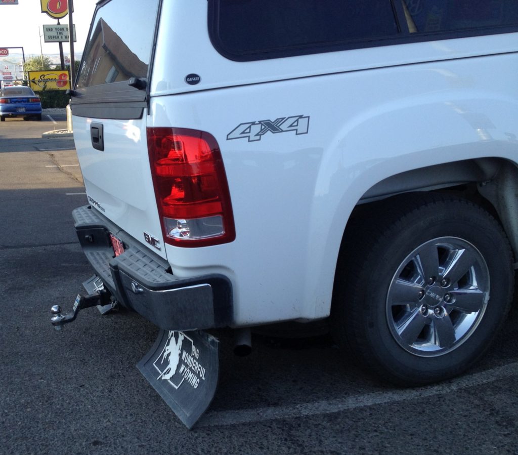 Overloaded truck with flaps on the ground heading to Alaska