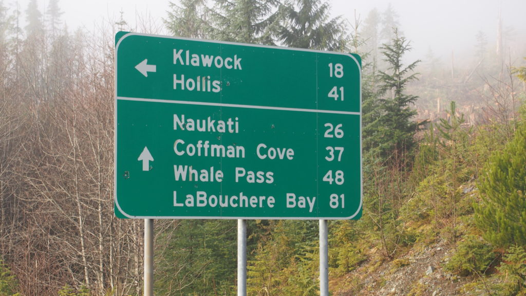 Sign with milage to communities on Prince of Wales Island, Alaska