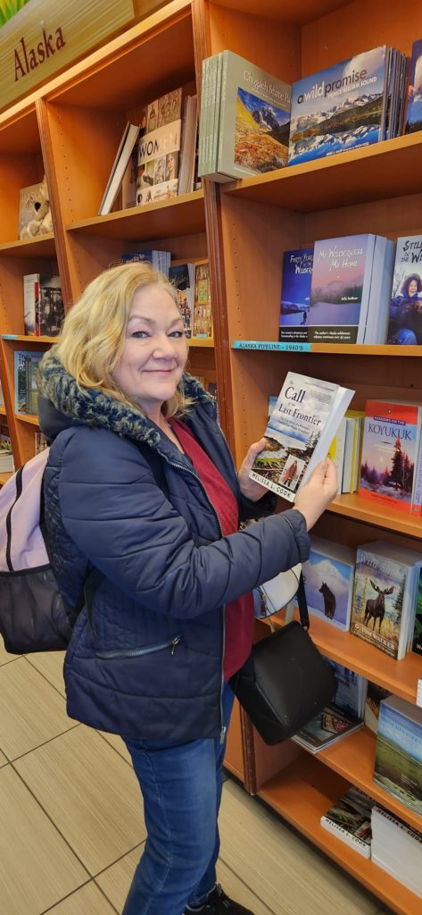 Melissa Billups holds The Call of the Last Frontier in Mosquito Books