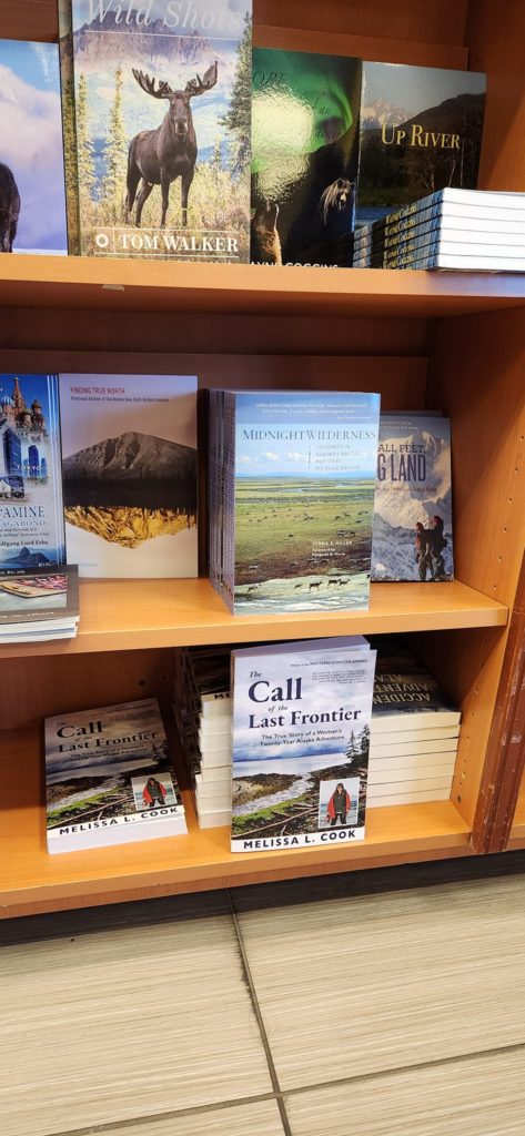 Melissa Billups holds The Call of the Last Frontier in Mosquito Books