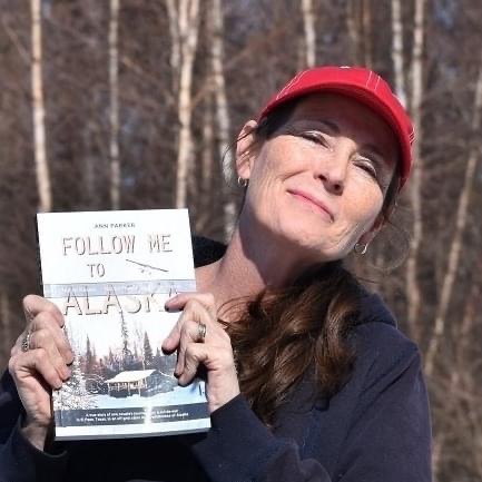Ann Parker holds her book Follow Me to Alaska