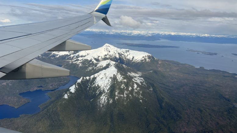 View from Alaska Airline jet coming into Ketchikan, Alaska, includes a snow-capped mountain and the Inside Passage waterway